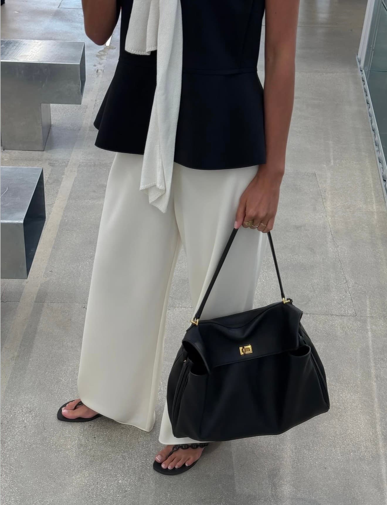 Black and ivory styling finished with a relaxed black leather handbag