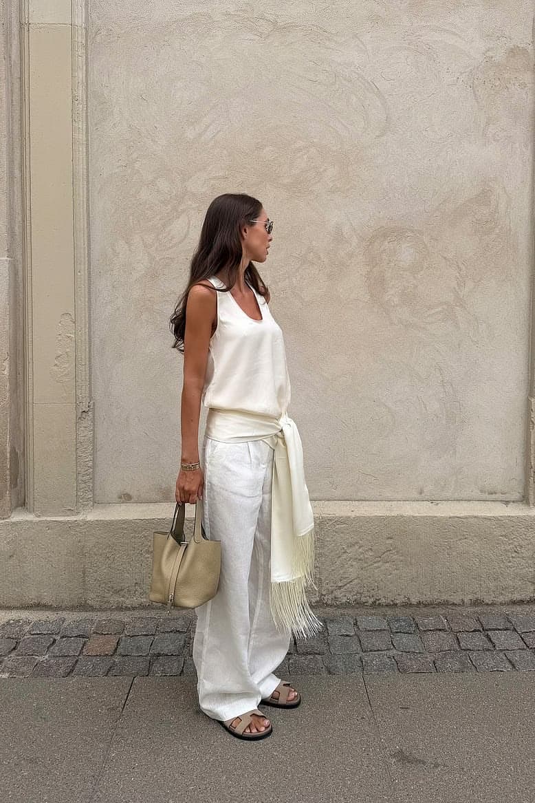 Fluid ivory dressing styled with a soft neutral bag